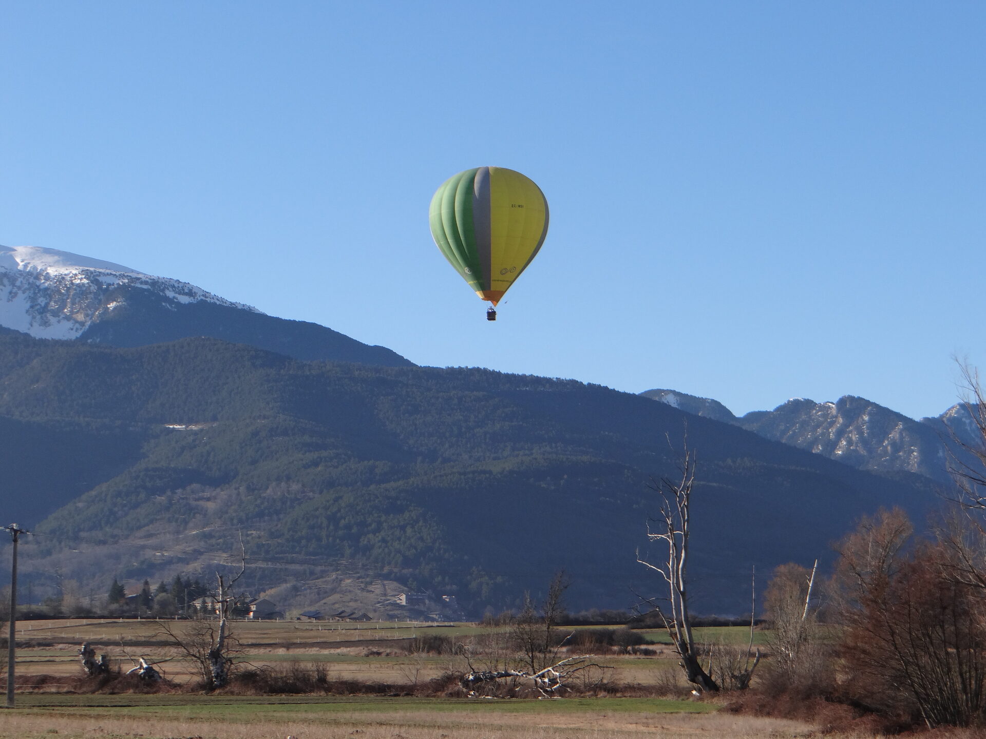 Hot air balloon drifting over the Catalan landscape at golden hour
