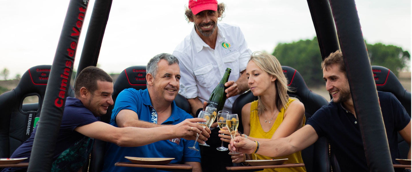 Cava and crystal glasses in the gastronomic hot air balloon basket over Catalonia